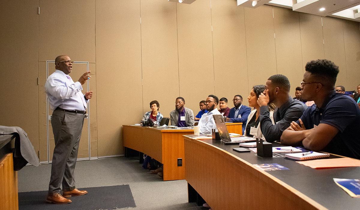 Graduate School staff member speaking to prospective students at Sloan boot camp