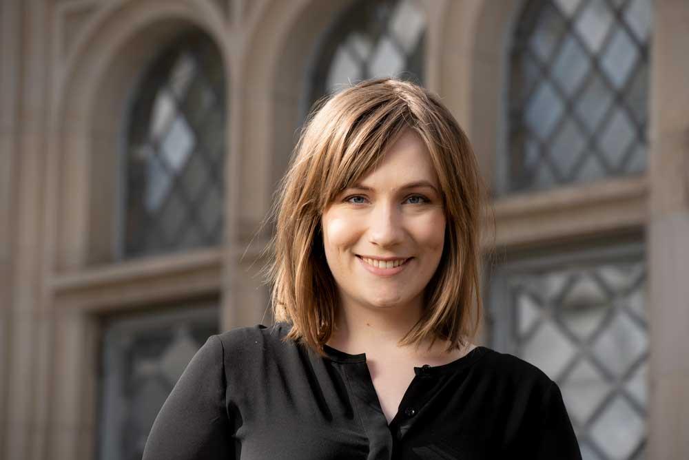 Headshot of Ashleigh Thomas, who is wearing a black shirt.