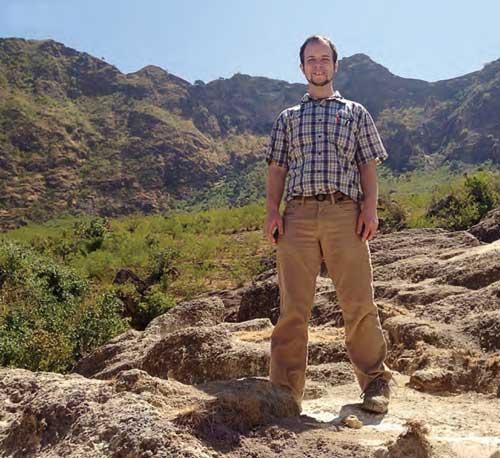 Chris Paul standing in nature with mountains in the background.