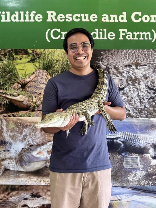 Galace posing with a baby crocodile