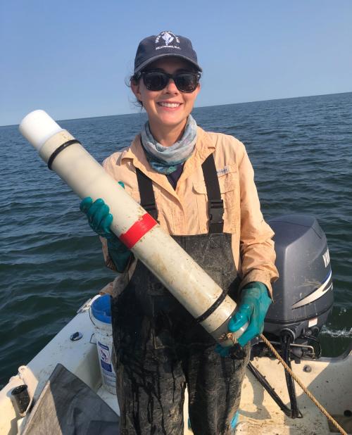 Ann-Marie Jacoby is holding a cleaned hydrophone she deployed in the Potomac River to collect data on bottlenose dolphin seasonal distribution.