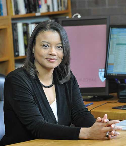 Tomiko Brown-Nagin sitting with her hands folded in front of her on a desk.